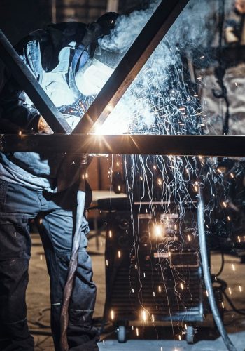 Welding work with metal construction at busy metal factory